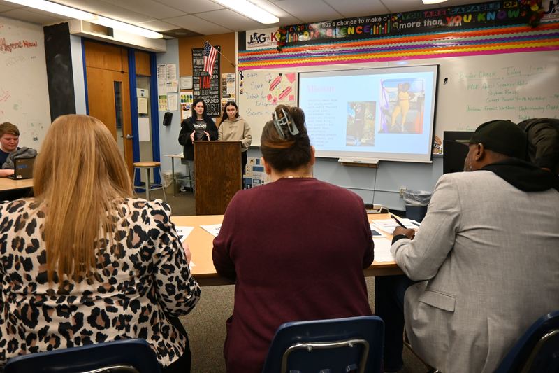 Judges listen as two girls pitch their business.