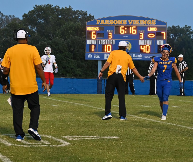 Coach Schibi congratulates Hentzen after a touchdown