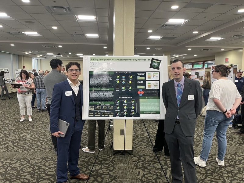 Ramirez stands with a chart detailing the outcome of a research project he conducted.