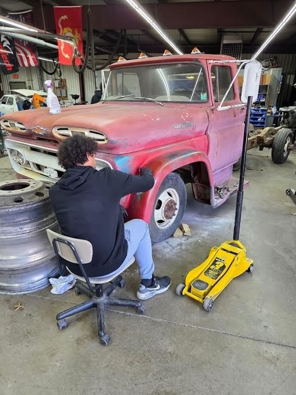 A student works on the front end of the Viking truck.