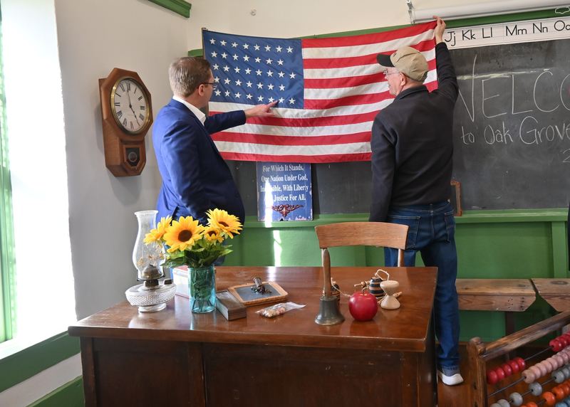 Pruitt and Toland talk about an old flag.