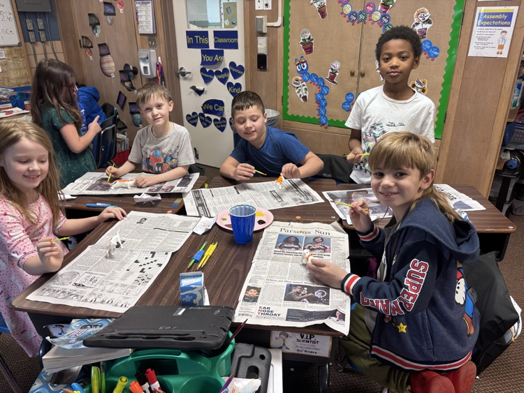 Students painting anias they are doing a writing project on.