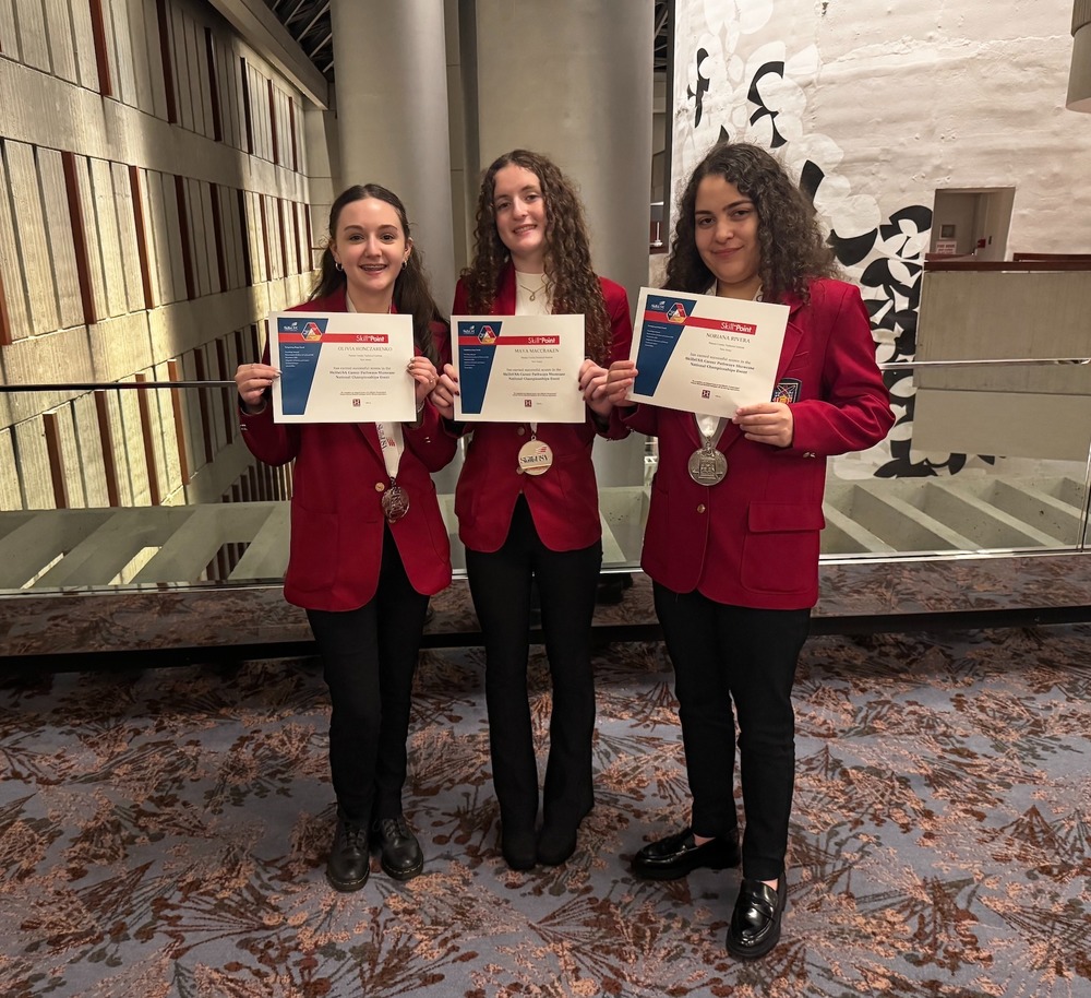 PCTI School of Education and Human Services students Olivia Honczarenko, Maya MacCracken, & Noriana Rivera, silver medalist at 2025 SkillsUSA National Leadership and Skills Conference in the Career Pathways Showcase: Human Services competition