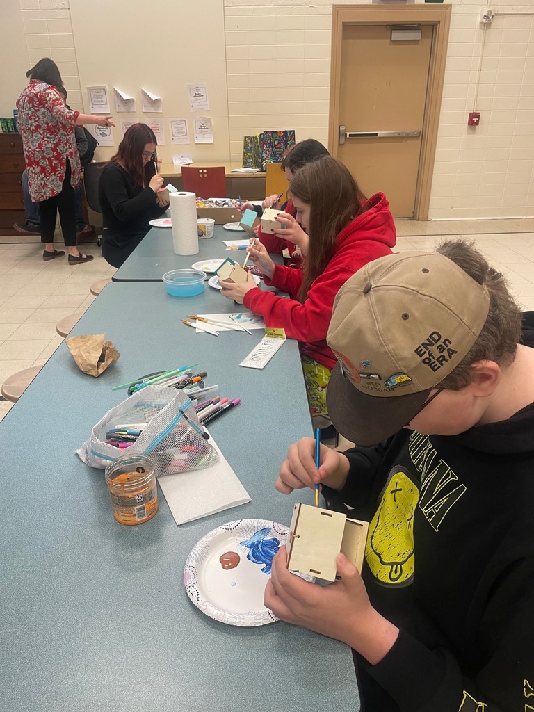 Students working on painting bird houses.