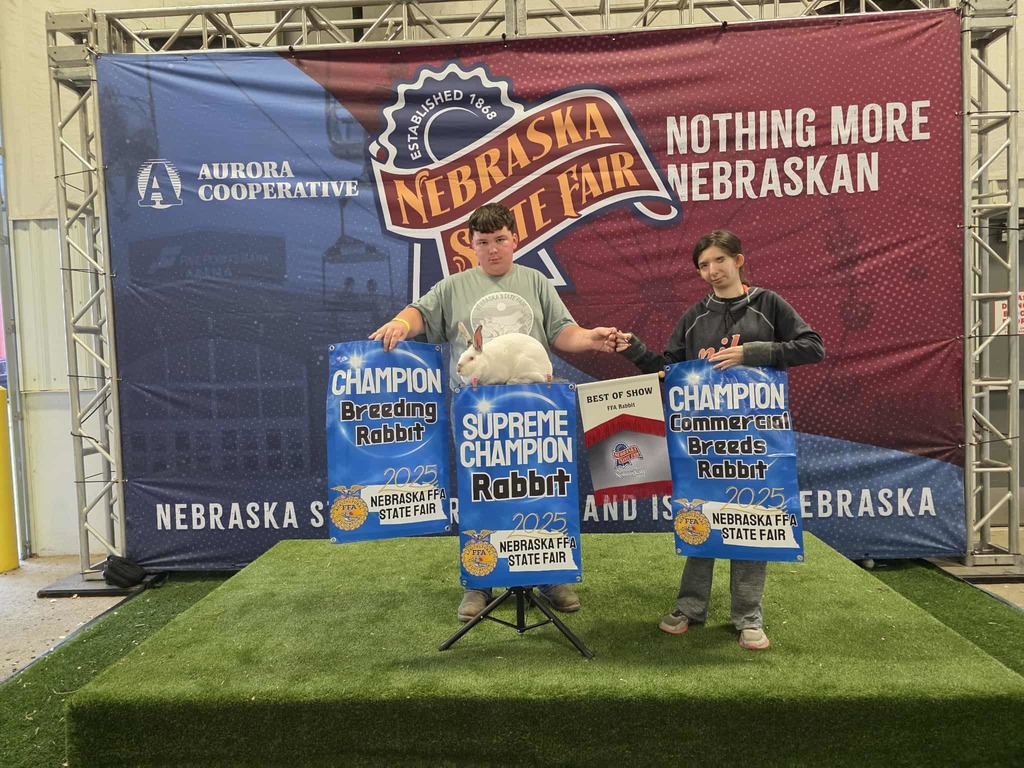 Banners read: Champion Breeding Rabbit, Supreme Champion Rabbit, Best of Show, and Champion Commercial Breeds Rabbit