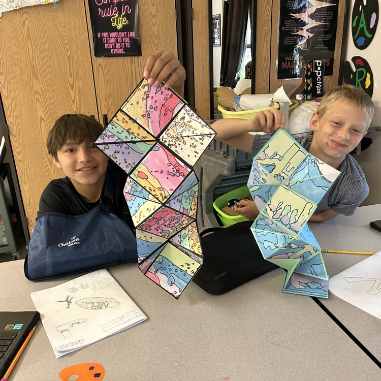 students holding artwork 