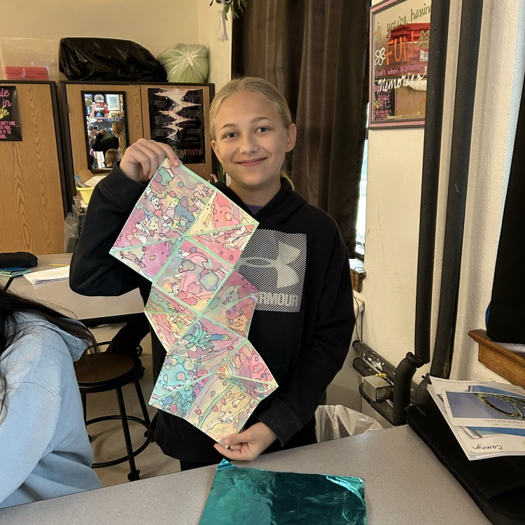 students holding artwork 