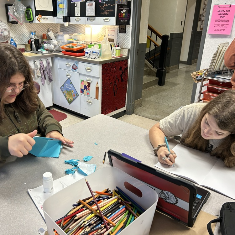 students holding artwork 