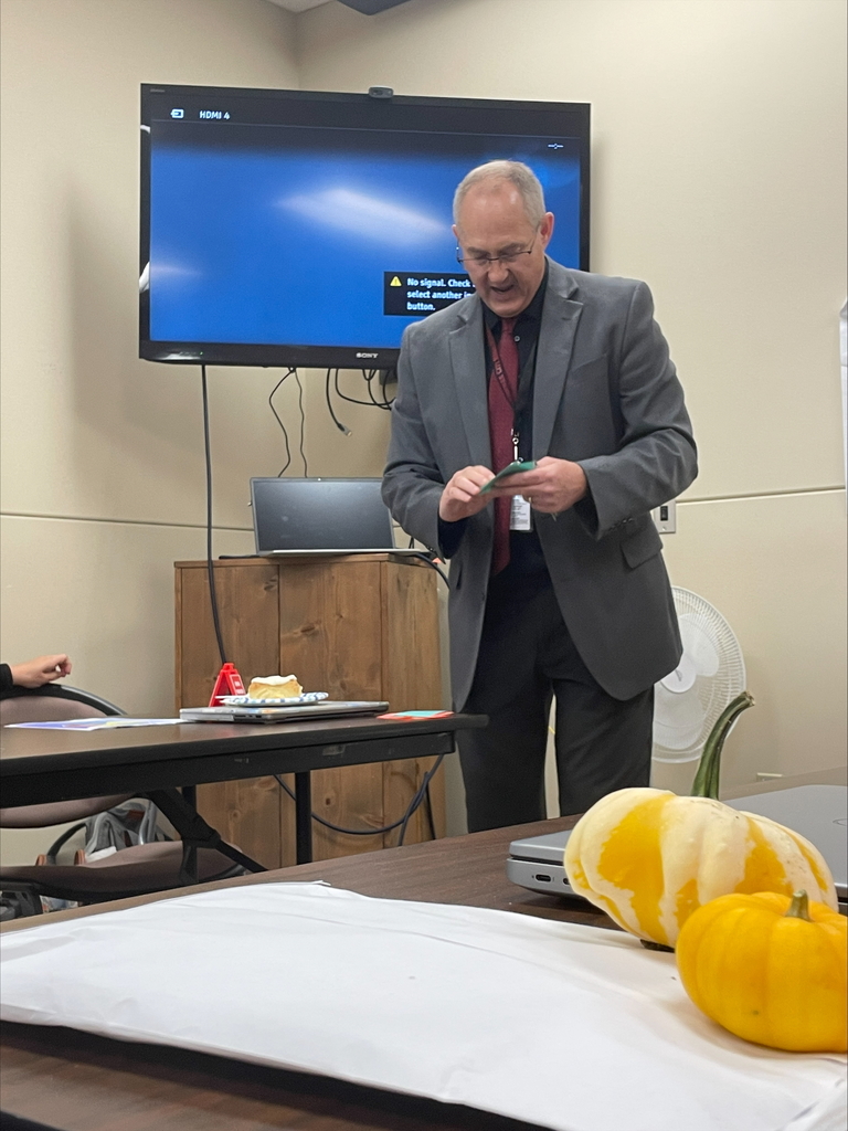 a man holding cue cards and presenting