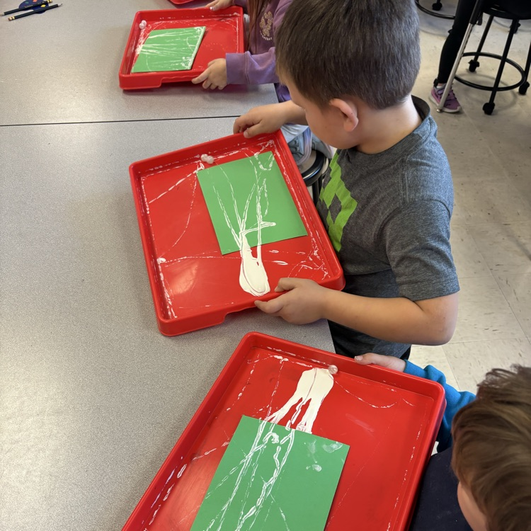 Student painting with marbles