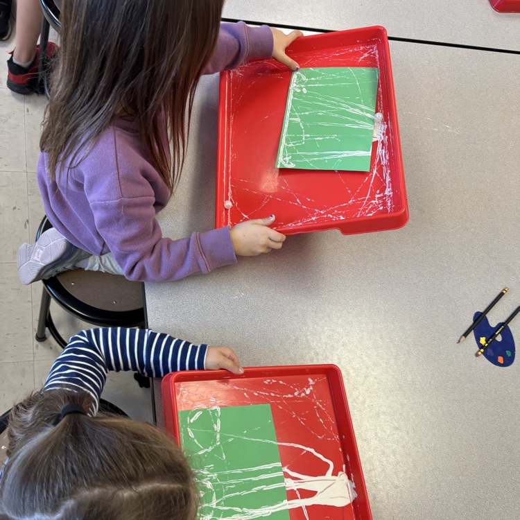 Student painting with marbles