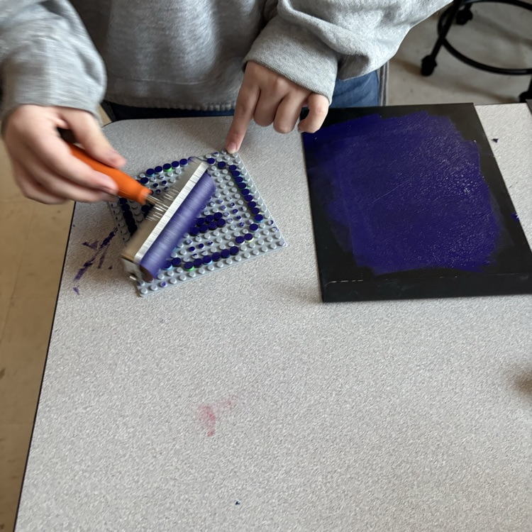 Adding ink to printing plate.