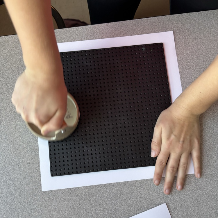 Transferring image from printing plate to paper.