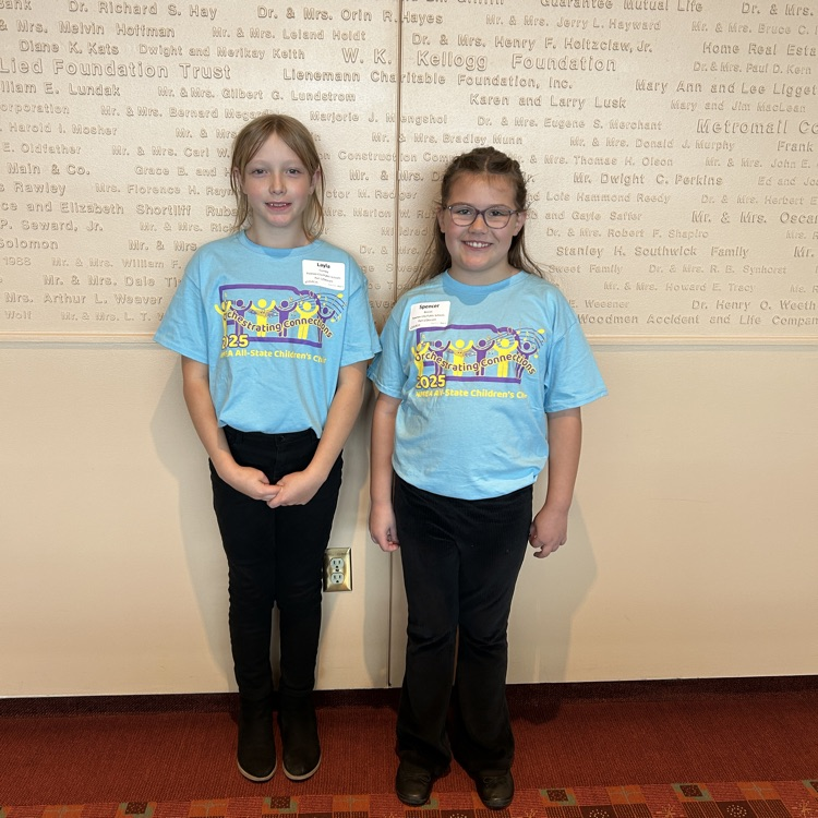 two children against a white wall