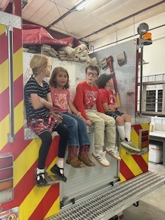 Sitting on the back of the truck.