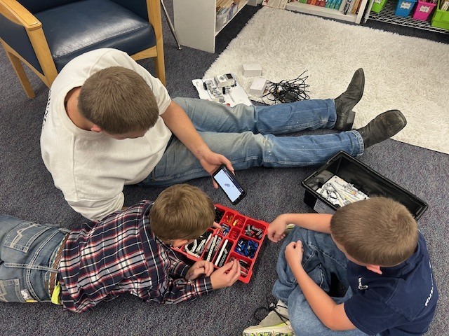The directions are on the phones, so the older students used their mobile devices to assist in building instructions. 