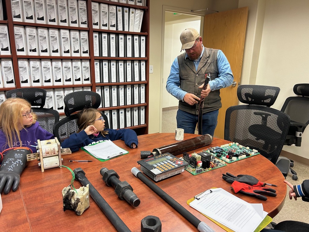 Mr. Ehmke explaining a turbine cable to students.