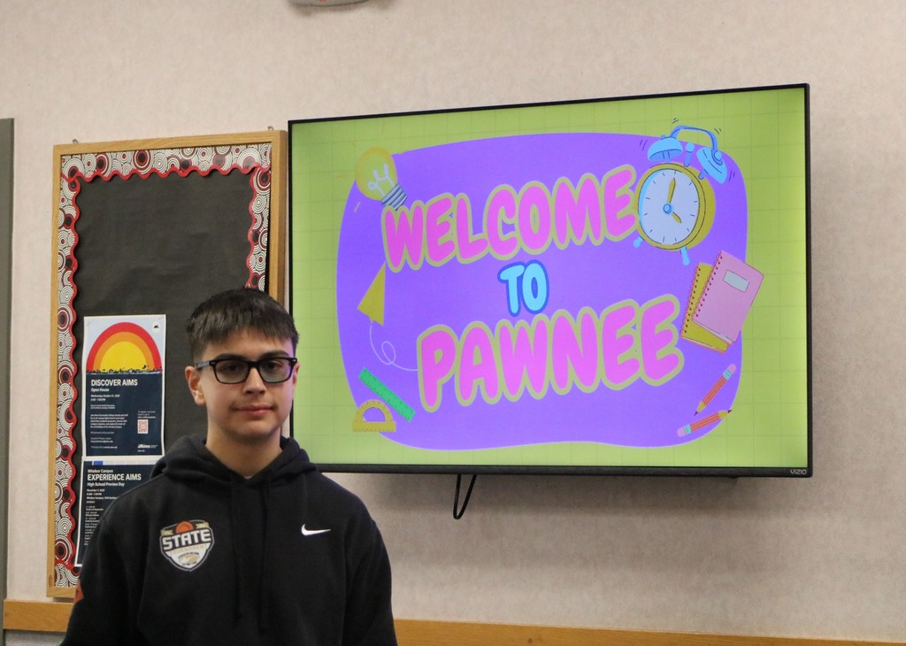 Jordan Garcia in front of Pawnee TV Announcements