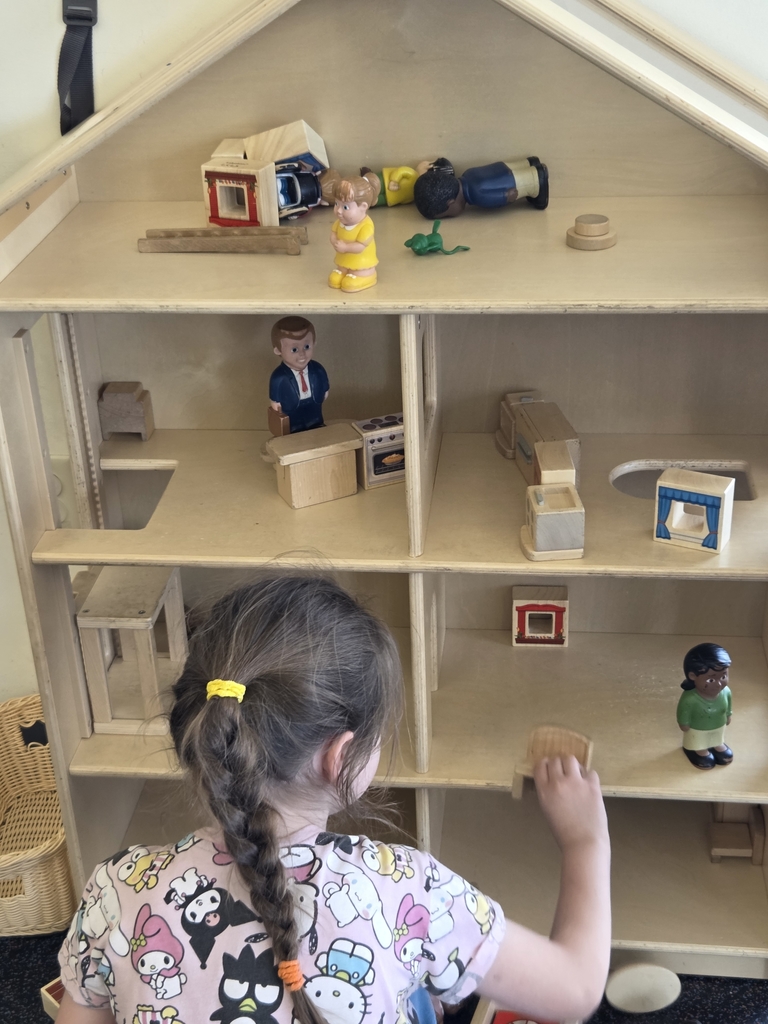 Lozen playing with dollhouse.