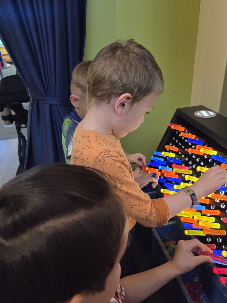 Students playing with Lite Brite. 