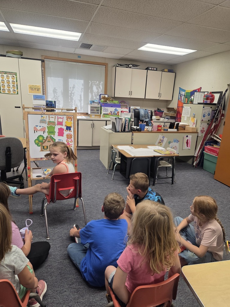 Lily is retelling the story of Goldilocks and the Three Bears to the third and fourth graders.