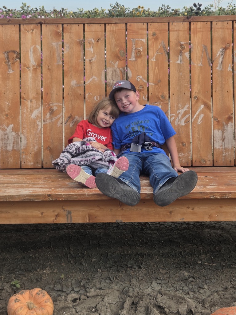Anna and Gus sitting on the swing.