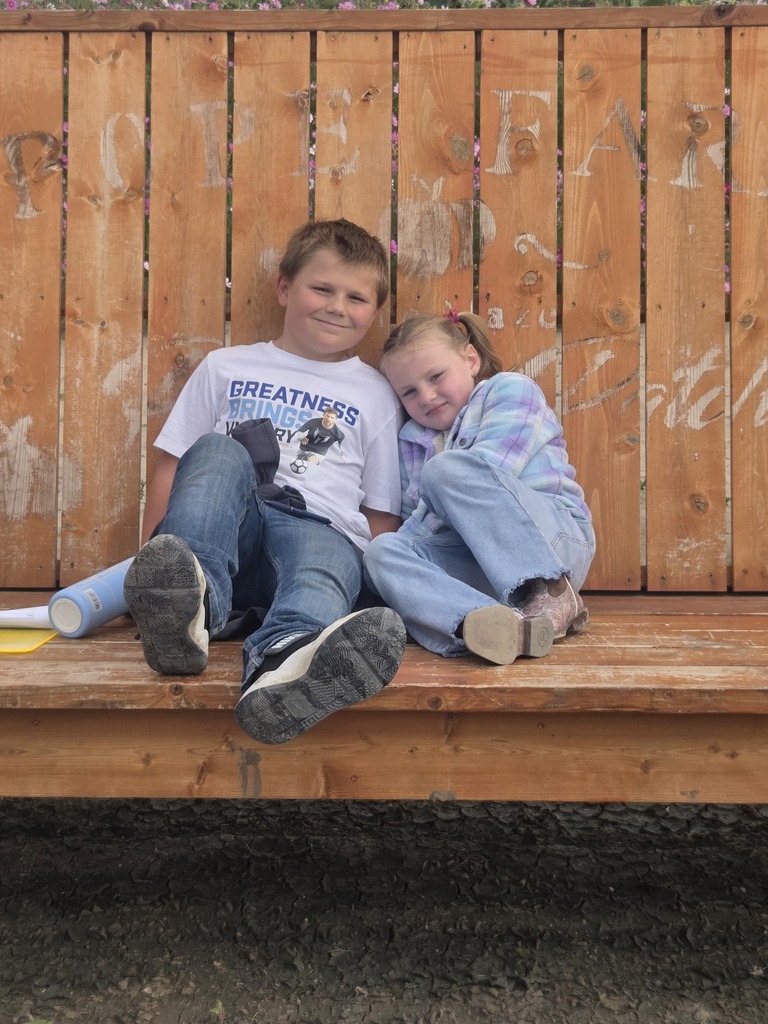 Clyse and Lily sitting on the swing.