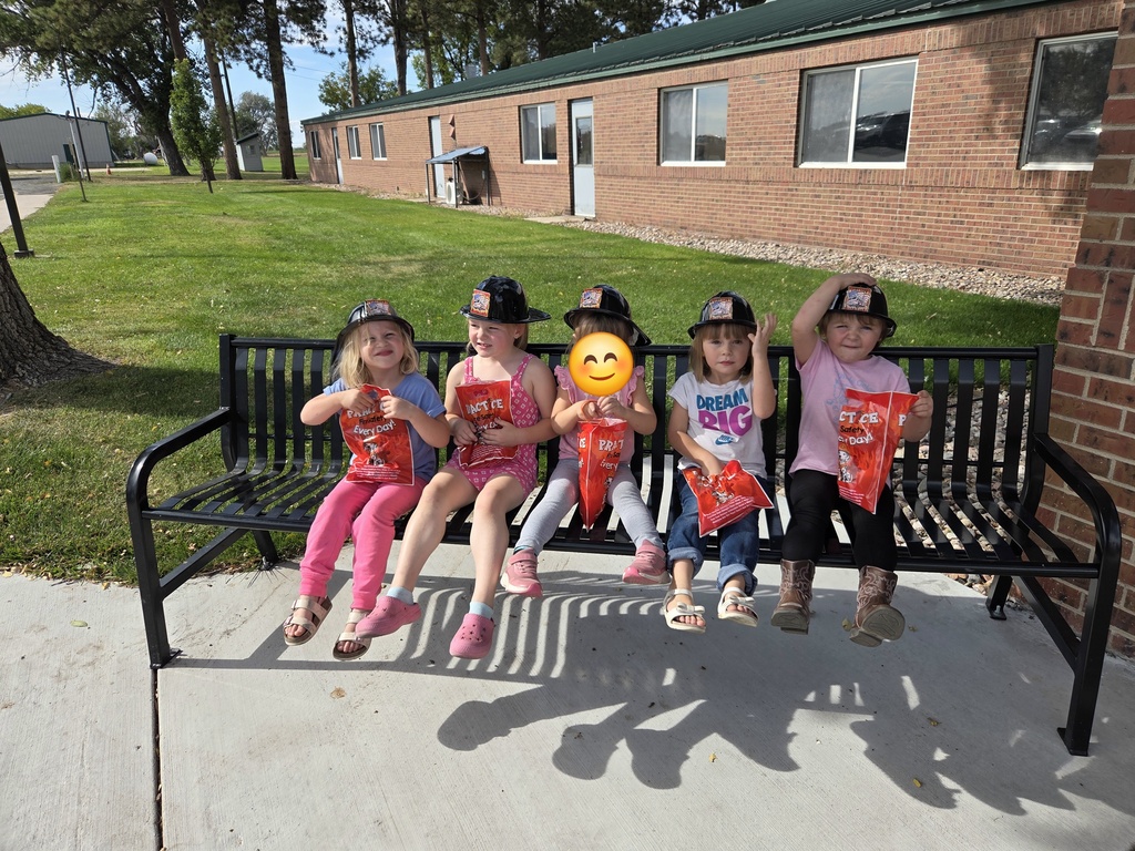 Students sitting with their goodie bag.