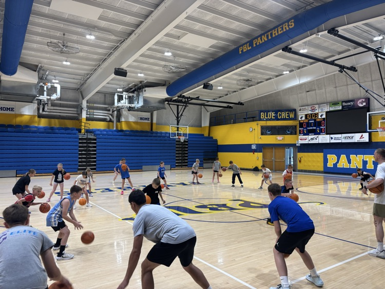 High schoolers work on ball handling with the campers.