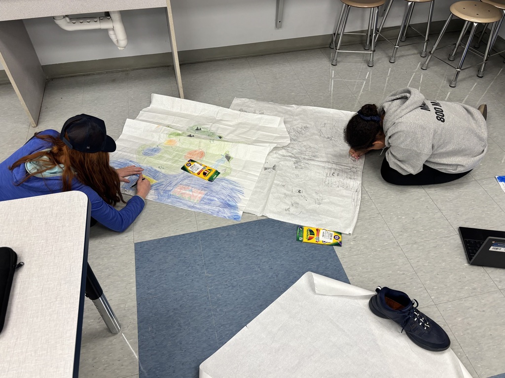 Students drawing on a map