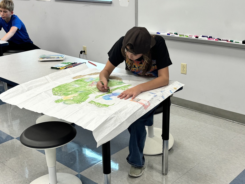 Student drawing on a map