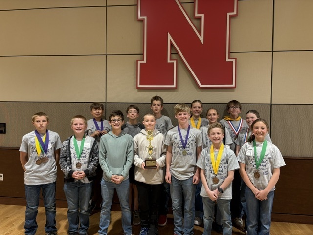Middle school Science Olympiad team with 6th place trophy.