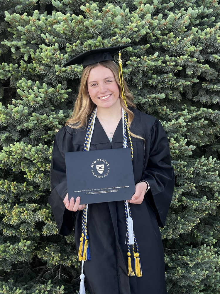 Ella outside with her degree. 