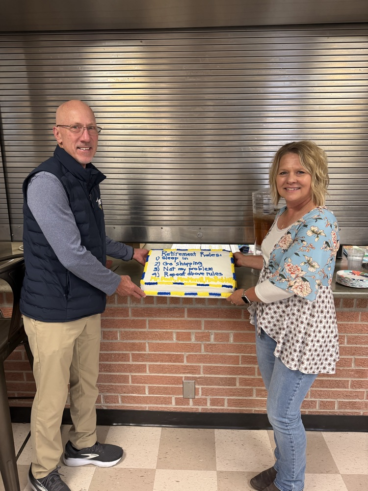 Mrs Merrill and Mr Dack with cake at retirement party .