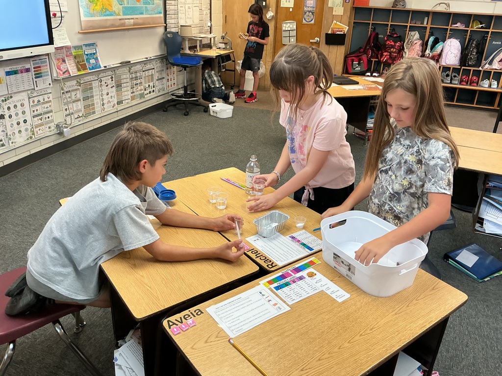 students testing water samples during science class