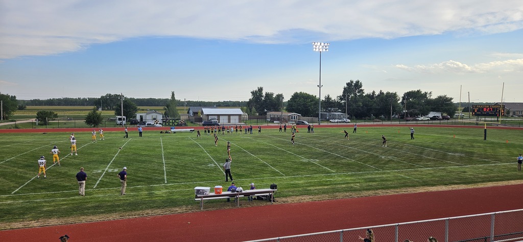 Tigers football with players on the field for the kickoff on a beautiful night
