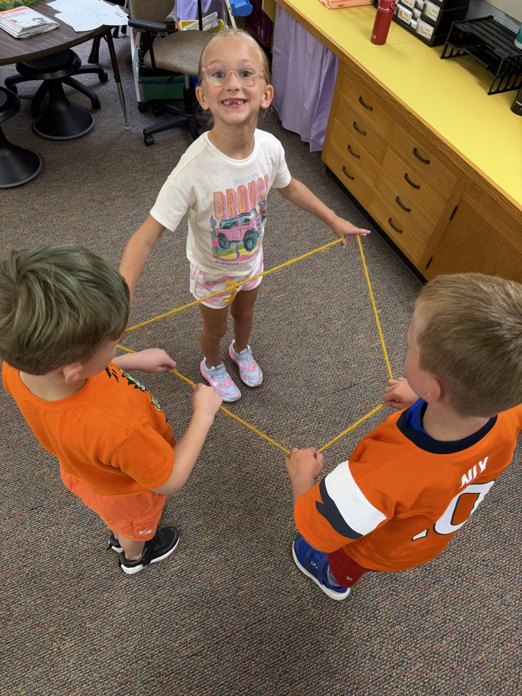 3 students building a shape with a rope