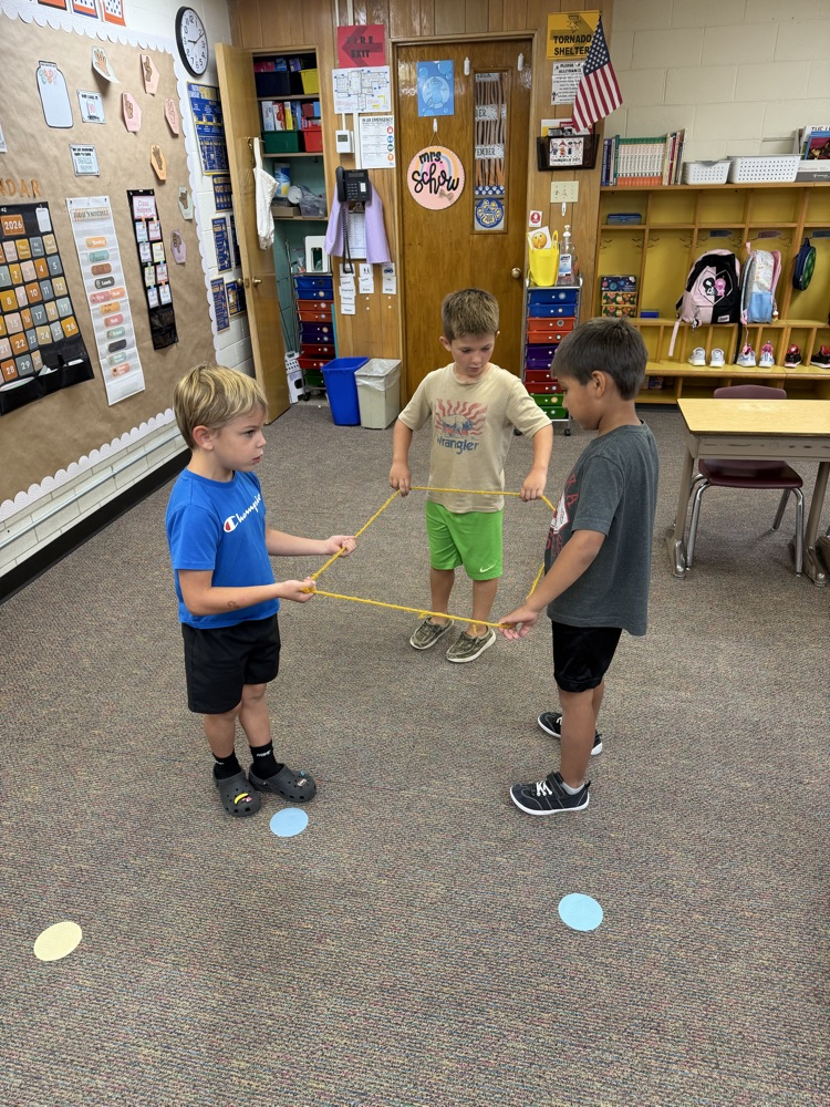 3 students building a shape with a rope
