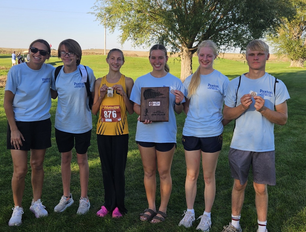 The Tiger cross country team holding up their medals and plaques