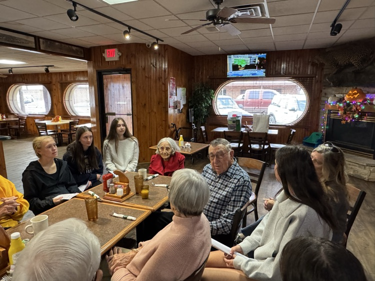 high school volleyball team visiting with the senior citizens at Ole’s during their luncheon 
