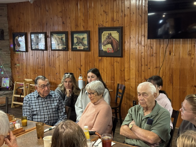high school volleyball team visiting with the senior citizens at Ole’s during their luncheon 