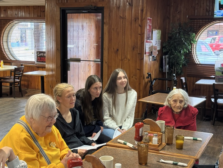 high school volleyball team visiting with the senior citizens at Ole’s during their luncheon 