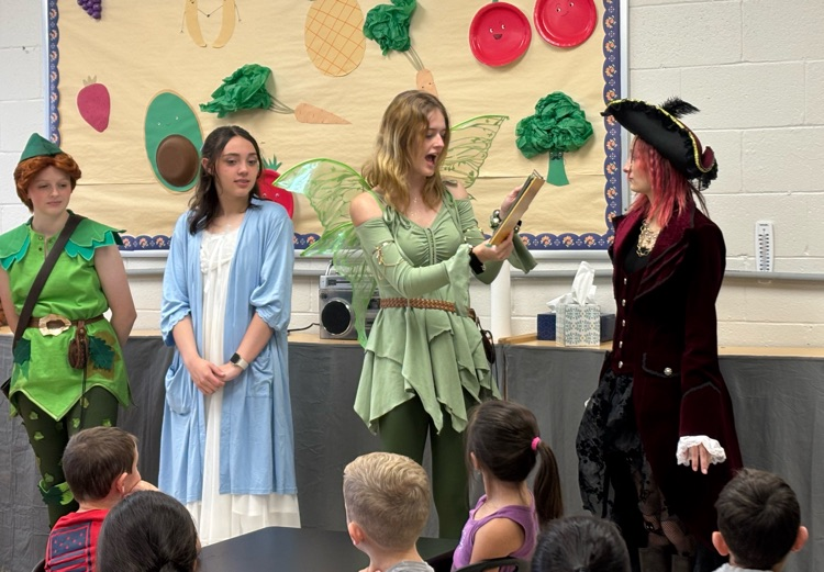 cast of Peter and Wendy reading to children