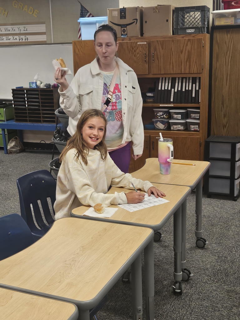student and teacher with doughnuts