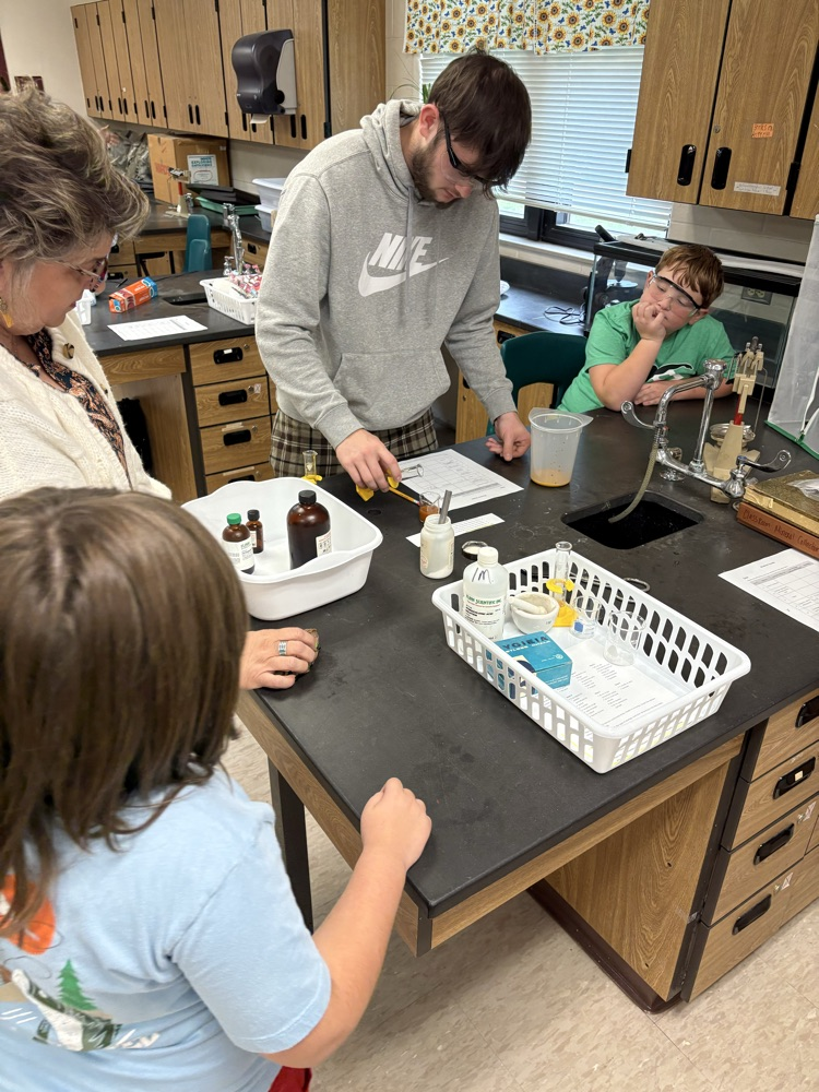 5th grade student working with high school chemistry to complete a physical/chemical change lab