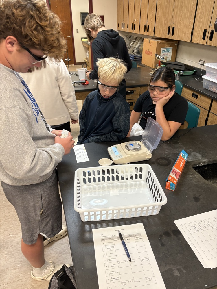 5th grade student working with high school chemistry to complete a physical/chemical change lab