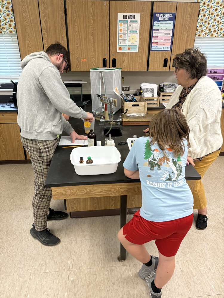 5th grade student working with high school chemistry to complete a physical/chemical change lab
