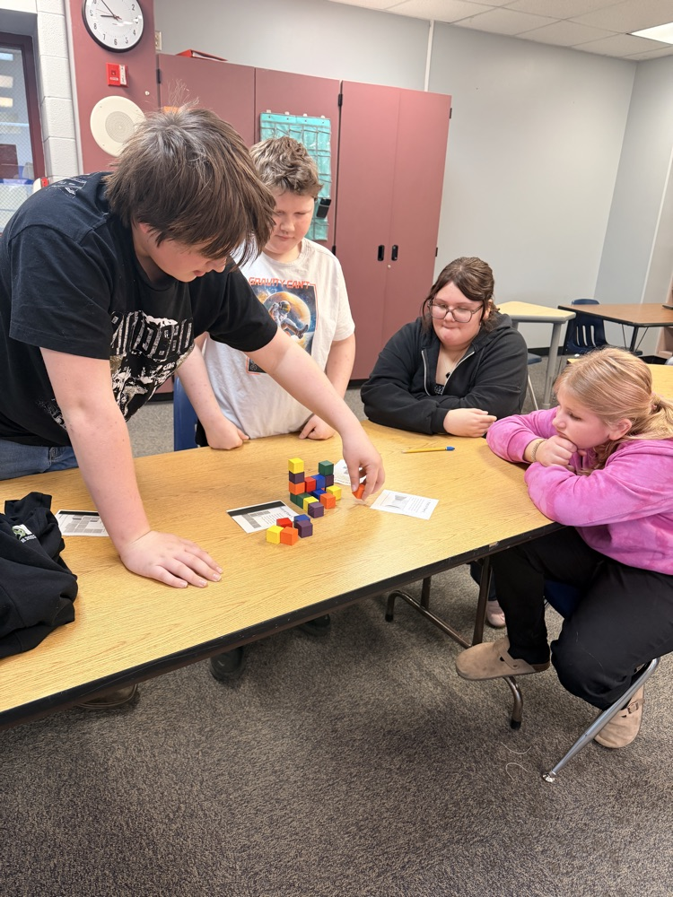 students working on building a structure out of blocks 