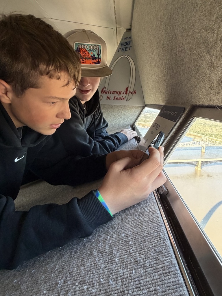 Students look out the window of the Arch