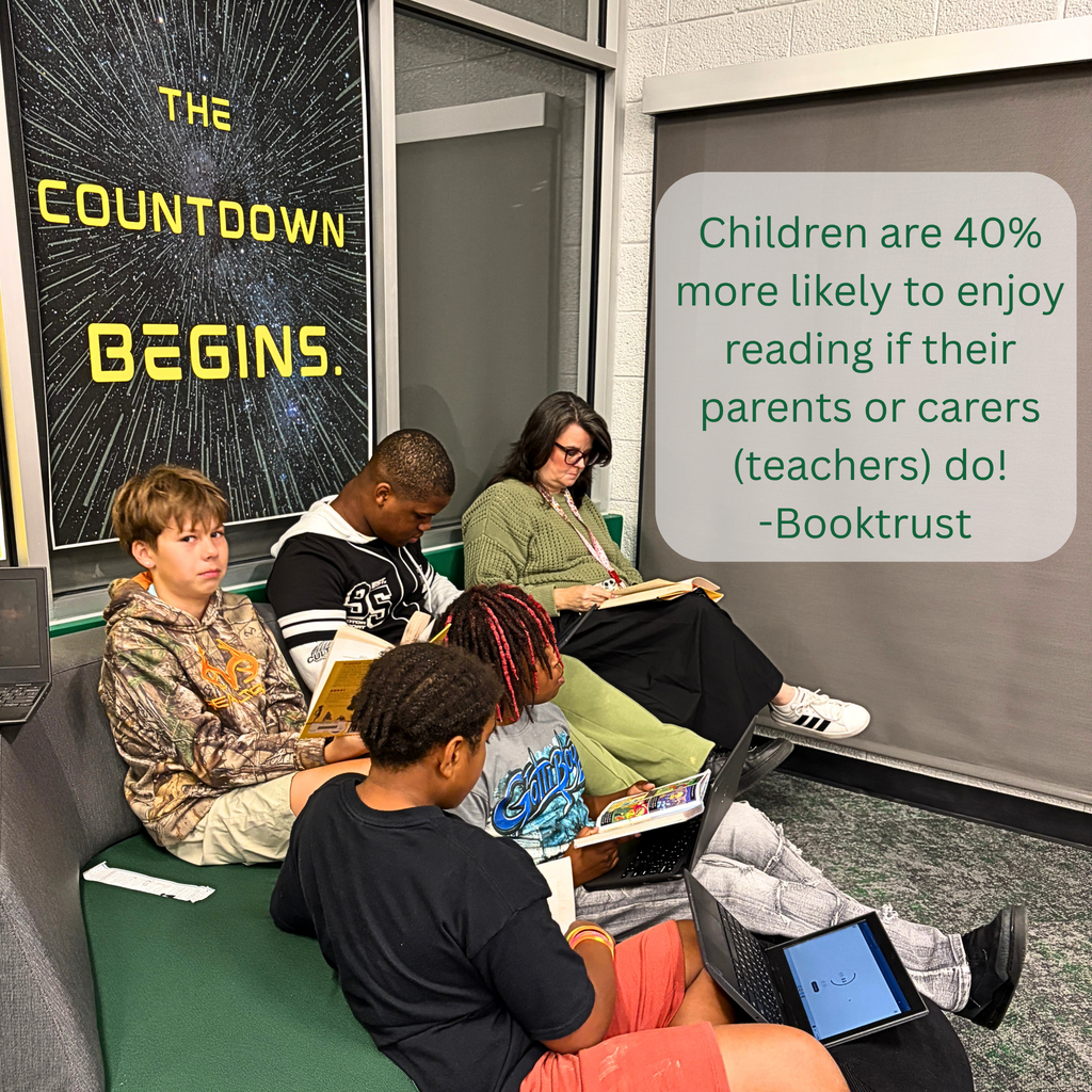 A teacher reads with her students during time in the Aerie!